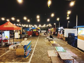 Illuminated street market at night