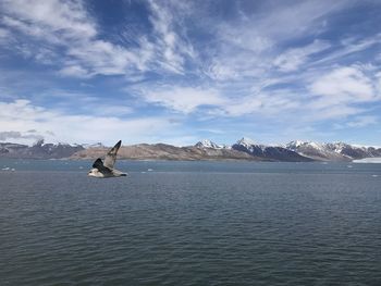 Scenic view of sea and mountains against sky