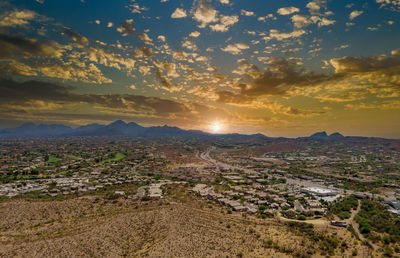 Aerial view of city against sky during sunset