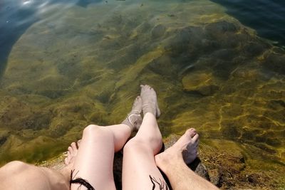 Low section of woman relaxing in sea