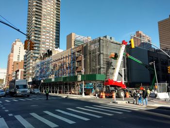 View of city street against blue sky