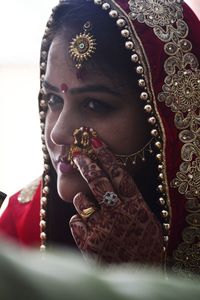 Close-up of woman wearing jewelry and sari during celebration