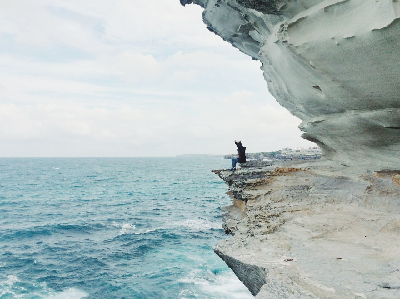 sea, water, horizon over water, sky, lifestyles, leisure activity, men, scenics, rock - object, nature, tranquility, beauty in nature, tranquil scene, waterfront, cloud - sky, rock formation, cliff, vacations