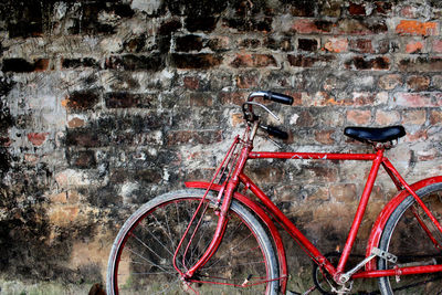 Bicycle parked against wall