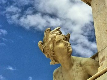 Low angle view of statue against cloudy sky