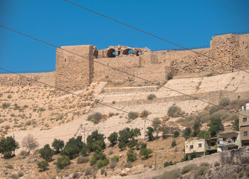 Built structure on mountain against clear blue sky