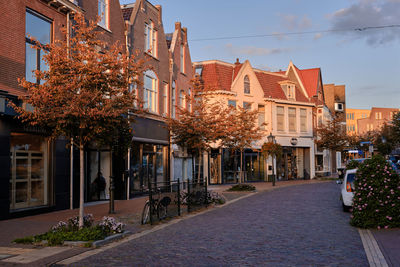 Bussum, the netherlands. havenstraat shopping street bathed in warm autumnal sunlight.