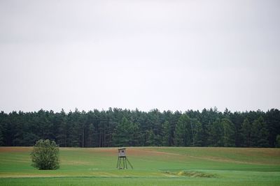 Scenic view of golf course against clear sky