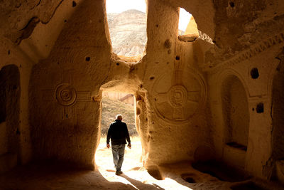 Rear view of man at historic building