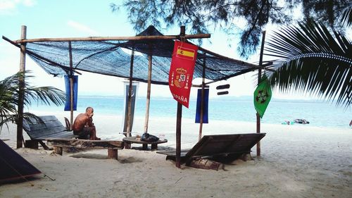 People at beach against sky