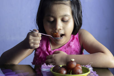 Portrait of girl child eating food