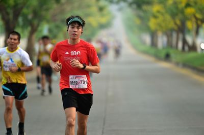 Full length of man running on road in city