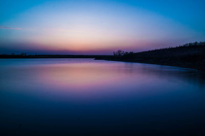 Scenic view of calm sea at sunset