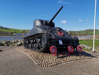 Metallic structure on road against sky