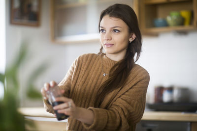 Young woman cooking in the kitchen