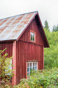 Exterior of abandoned house against clear sky