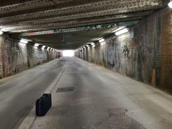 Empty road in illuminated tunnel