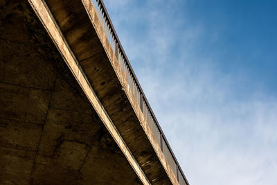 Low angle view of bridge and building against sky