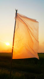 Scenic view of field against sky during sunset