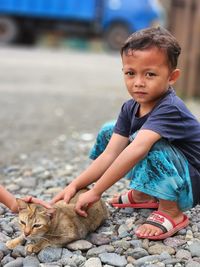 Kids pating a cat
