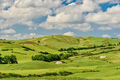 View of golf course against cloudy sky