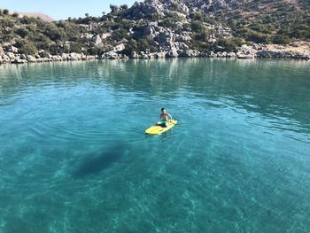 Man surfing on boat in sea