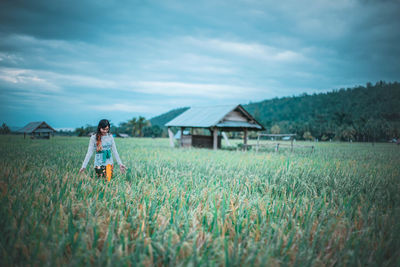 Woman on field against sky
