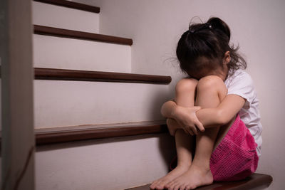 Low section of woman sitting on floor