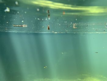 Full frame shot of wet glass with sea