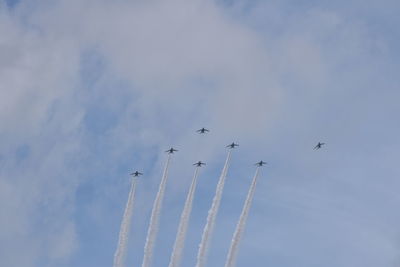 Low angle view of airplane flying against sky