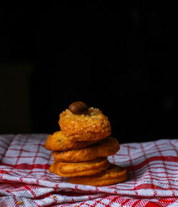 Close-up of bread on table against black background