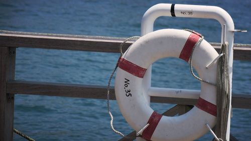 Life belt on boat railing in sea