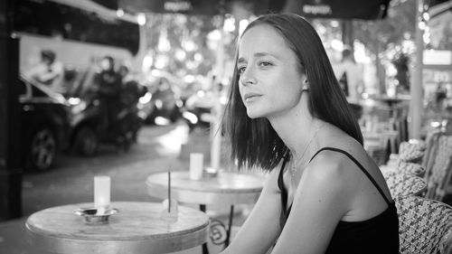 Woman looking away while sitting in cafe