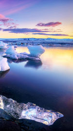 Scenic view of lake against sky during sunset