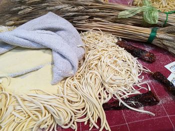 High angle view of pasta and dried chili peppers on table