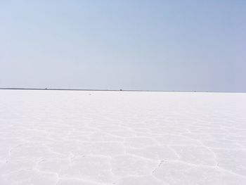 View of snow covered landscape against clear sky