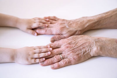 Close-up of woman hand over white background