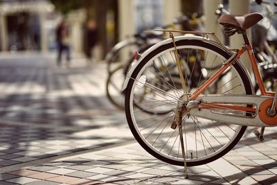 Close-up of bicycle wheel in city