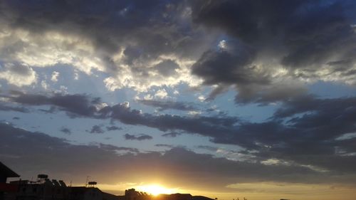 Silhouette buildings against sky during sunset