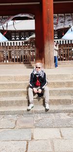 Man sitting on staircase of building