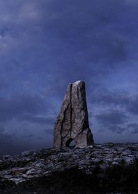 Low angle view of rock formation against sky