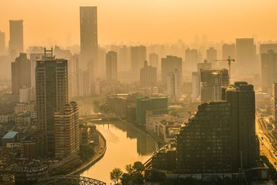 High angle view of buildings in city against sky during sunset