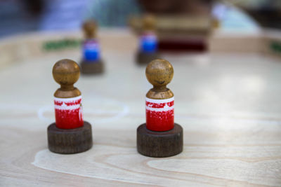 Close-up of wooden chess pieces on table