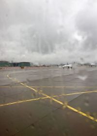 Airplane on runway against sky