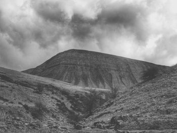 Scenic view of mountains against cloudy sky