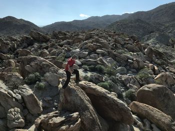 Rear view of man with mountains in background