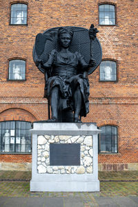 Statue against building
