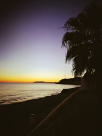 Scenic view of sea against clear sky at sunset
