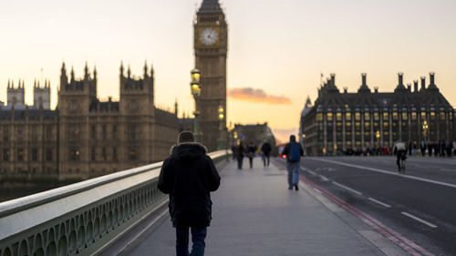 People walking on bridge in city