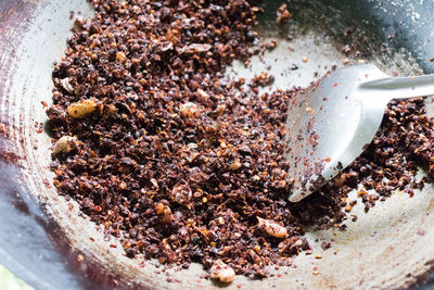 Stir in dried chilies in a frying pan